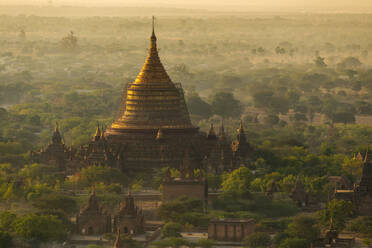 Myanmar, Mandalay Region, Bagan, Aerial view of ancient Buddhist temple at foggy dawn - TOVF00208