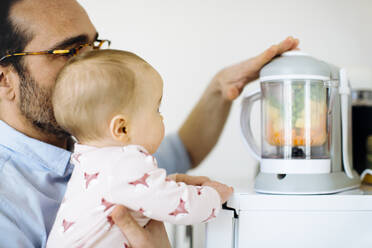 Father showing his baby girl a mixer - SODF00793