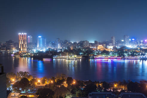 Egypt, Cairo, Nile and city skyline illuminated at night - TAMF02461