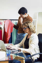 Female fashion designers working in office - JSRF00977