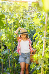 Girl with basket in garden - LJF01598