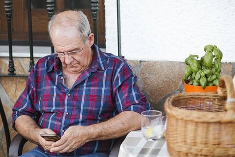Senior man using smartphone stock photo