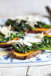 Toasted slices of sweet potato with spinach and parmesan cheese topping - SBDF04264