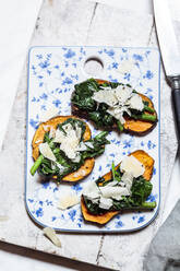 Toasted slices of sweet potato with spinach and parmesan cheese topping - SBDF04265