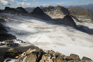 Hikers cross Snowbird Glacier, Talkeetna Mountains, Alaska - CAVF86626