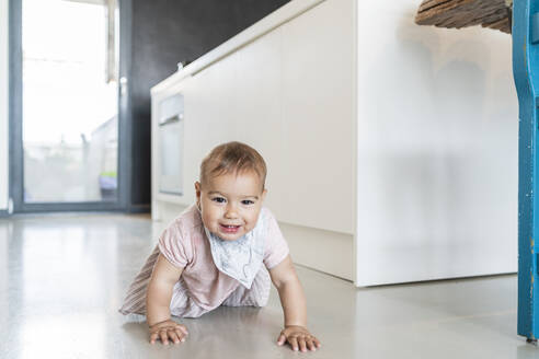 Cute baby girl crawling on floor in modern kitchen at home - JAF00036