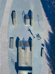 Man with bicycle in skate park, aerial view - KNTF04775