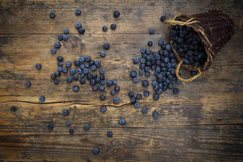 Fresh blueberries spilling from wicker basket - LVF08970