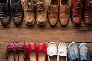 High Angle View Of Various Shoes On Wooden Table - EYF09263