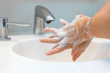 Cropped Image Of Woman Washing Hands In Bathroom Sink - EYF09282