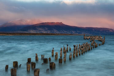Wooden Posts In Sea Against Sky During Sunset - EYF09362
