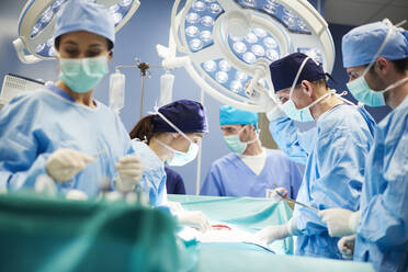 Doctors Operating Patient In Emergency Room - EYF09454