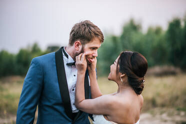 Smiling Newlywed Couple On Field - EYF09484