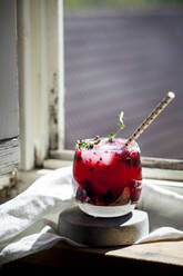 Wild berry thyme smash with wild berries, thyme, tequila, and sparkling water - SBDF04297