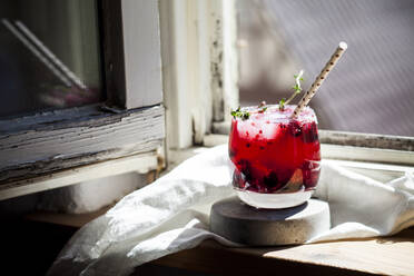 Wild berry thyme smash with wild berries, thyme, tequila, and sparkling water - SBDF04298