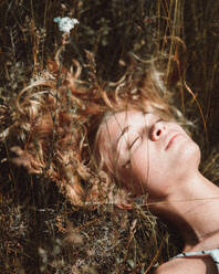 Close-Up Of Woman Lying By Plants - EYF09561