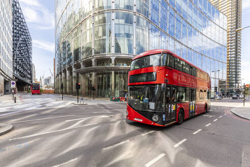 UK, London, Red double decker bus # with modern buildings in background - WPEF03162