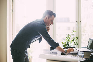 Profile of man on the phone in office at home - MASF18570