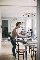 Woman accessing online meeting working at home - MASF18594