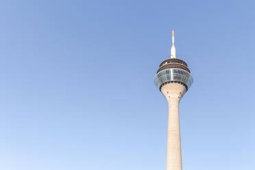 Germany, North Rhine-Westfalia, Dusseldorf, Rhine Tower standing against clear blue sky - MMAF01338