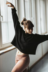 Young female ballerina dancing in studio - DAWF01739