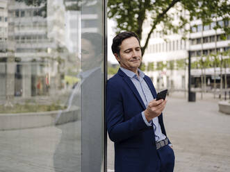Mature businessman using smartphone in the city - JOSEF01188