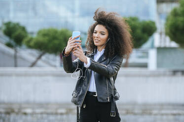 Junge Afro-Frau nimmt Selfie von Smartphone - KIJF03174