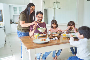 Family eating lunch at dining table - CAIF28297