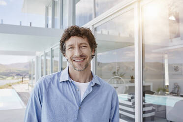 Portrait of a confident man at luxury beach house - RORF02229