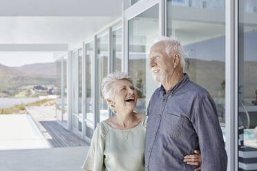 Happy senior couple at luxury beach house - RORF02267