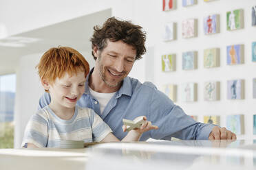 Father playing with happy son in a villa - RORF02278