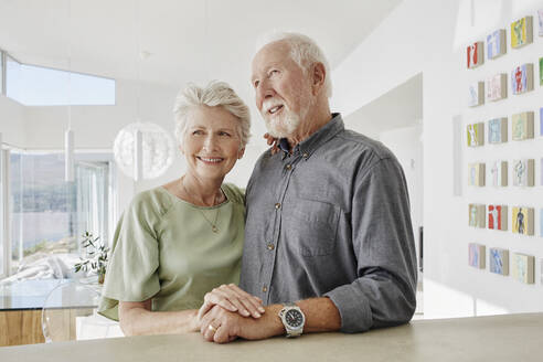 Lächelndes Seniorenpaar in einer Luxusvilla - RORF02295