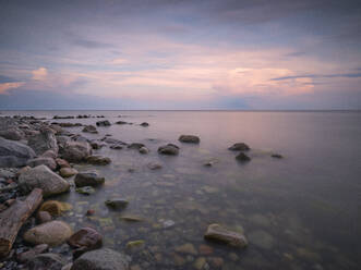 Germany, Mecklenburg-Western Pomerania, Rocky shore of Rugen island at dusk - HAMF00675