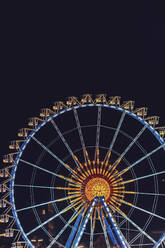 Germany, Bavaria, Munich, Aerial view of illuminated Ferris wheel at night - MMAF01362