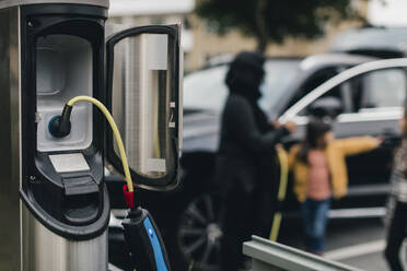 Cable connected to electrical outlet at car charging station - MASF19162