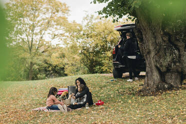 Eltern mit Töchtern beim Picknick im Herbst - MASF19169
