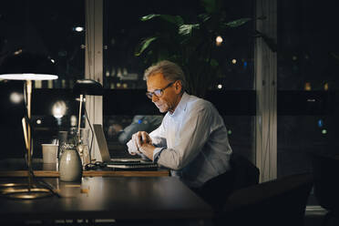 Dedicated senior male professional working late at creative workplace - MASF19373