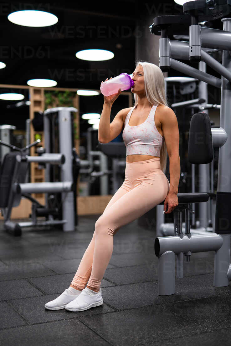 Sporty Beautiful Blond Woman In Sportswear Working Out Indoors