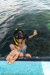 Young cheerful lady with snorkel in water - ADSF00301