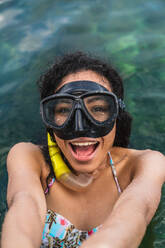 Young cheerful lady with snorkel in water - ADSF00302