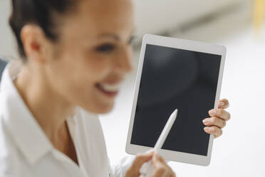 Close-up of female entrepreneur using digital tablet in home office - JOSEF01304