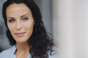 Close-up of confident woman with gray eyes outside cafe - JOSEF01418