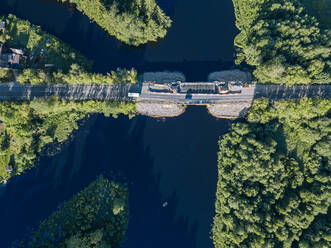 Russia, Leningrad Oblast, Tikhvin, Aerial view of bridge over Tikhvinka river in summer - KNTF04934