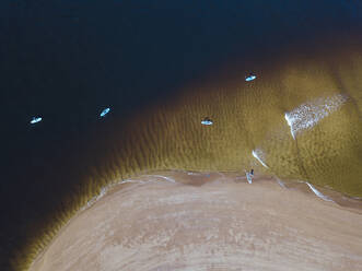 Aerial view of people surfing in coastal waters of Barents Sea - KNTF04949