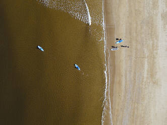 Aerial view of surfers on sandy coastal beach of Barents Sea - KNTF04952