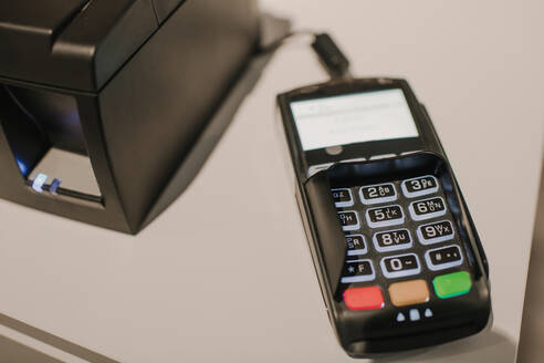 Closeup shot of modern payment terminal lying on counter in modern�store - ADSF00564