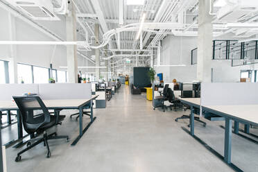 Interior shot of light white and black design of open space office with modern illumination - ADSF00577