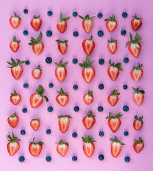 Halves of strawberries lying in row - ADSF00589