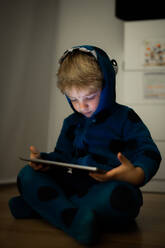 Caucasian boy watching cartoons in a tablet - ADSF00740