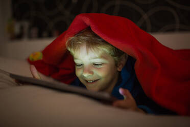 Caucasian boy watching cartoons in a tablet - ADSF00745